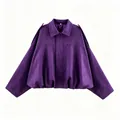 Detail view of a purple faux suede jacket with batwing sleeves and fashionable gathered hem - XS / Tops / Purple