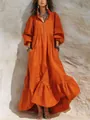 Detail of bohemian orange maxi dress featuring ruffled tiered hem and front zipper - S / Dresses / Orange Red
