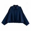Close-up detail of navy blue faux suede bomber jacket with stylish batwing sleeves - XS / Tops / Navy Blue