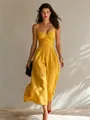 Elegant yellow spaghetti strap pleated maxi dress worn by a model in soft daylight. - S / Dresses / Earthy Yellow