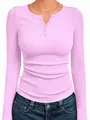 Detail view of pink ribbed Henley top with long sleeves and decorative button neckline - Bright Pink