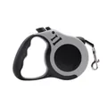 Grey retractable dog leash with ergonomic handle and bone-shaped design details - Gray
