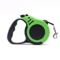 Retractable green and black pet leash featuring an ergonomic handle and secure metal clip - Green