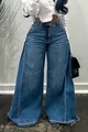 Close-up of blue washed wide-leg denim pants with patchwork design and frayed hem - S / Blue