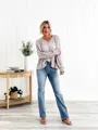 Full-length view of women's blue micro-flare jeans styled with a mauve lace-trim blouse. - XS / Bottom (Ankle Length) / Light Blue