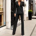 Detail view of a black two-piece suit with a single-button blazer and straight-leg trousers. - S / Top And Bottom / Black