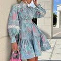 Close-up of floral print mini dress with lace-trimmed puff sleeves and high neck. - S / Dresses / Light Blue
