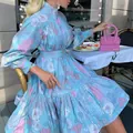 Close-up of summer floral high-neck shirt dress in a stylish cafe setting - S / Dresses / Blue
