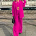 Detailed view of fashionable magenta three-piece suit set with blazer, top and pants - L / Set / Rose Red