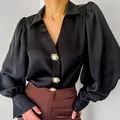Detailed view of elegant black satin blouse with lantern sleeves and pearl buttons. - S / Tops / Black