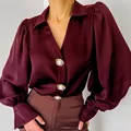 Detailed view of burgundy satin shirt with elegant puff sleeves and decorative buttons - S / Tops / Burgundy