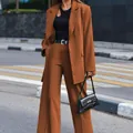 Full-body view of a stylish brown two-piece blazer and wide-leg trouser suit set. - S / Top And Bottom / Coffee