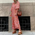 Detail view of a vibrant orange bohemian printed maxi dress with stylish puff sleeves - S / Dresses / Orange