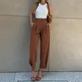 Detail of high-waisted brown pleated trousers with matching belt and button hem - S / Bottoms / Coffee
