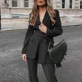 Elegant black two-piece suit set with tie-waist blazer and trousers on a street - S / Top And Bottom / Black