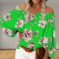Close-up of vibrant green off-shoulder floral print top featuring elegant puff sleeves - S / Tops / Green