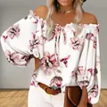 Detail shot of off-the-shoulder floral print blouse featuring bell sleeves and neck tie - S / Tops / White