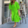 Macro view of the vibrant neon green puff sleeve resort midi dress worn by a model - S / Dresses / Grass Green