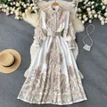 Detailed view of a vintage paisley print long sleeve shirt dress with matching belt. - S / Dresses / Apricot