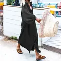 Elegant loose black long-sleeve maxi dress with textured fabric and button details - Black
