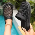 Close-up of stylish black woven mesh slippers with a thick platform sole for women - 35 / Black
