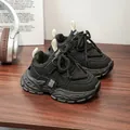 Close-up detail of stylish black chunky sneakers for kids presented on a wooden table - Size 28 Length 17.4cm / Style 8288 / Black