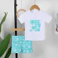 Two-piece boys swimsuit featuring white short sleeve top and palm tree print shorts - 7Y / Top And Bottom / Cyan