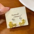 Elegant gold carousel horse and flower earrings set with sparkling crystal studs for women - Copper Coin Merry-go-round Earrings (MMW39)