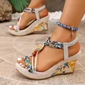 Detail view of bohemian wedge sandals with colorful woven straps and stone accents - 35 / Off White