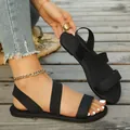 Detail of women's black flat beach sandals with elastic straps on a wooden boardwalk. - 36 / Roman Style (54#) / Black