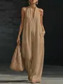 Model posing in an elegant khaki sleeveless halter jumpsuit with a wide-leg design - Camel