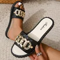 Detailed macro view of black quilted strap with rhinestone-encrusted gold chain links - 36-37 / Black
