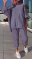 Outdoor lifestyle shot of a woman wearing a casual lavender two-piece leisure set - Top And Bottom / S / Purple