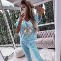 Mirror selfie detail showing the light blue sequined evil eye set in a sunroom setting. - Light Blue