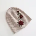 Detail shot of exquisite red flower embroidery on warm oatmeal knitted beanie hat - Flower Hat