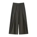 Detailed view of dark olive women's wide-leg pleated trousers with a loose fit design - XS / Bottoms / Green