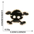 Detailed dimension view of a black and white skull embroidered patch for DIY crafts - Skull (3) / 3.1x2.2cm