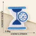 Detailed blue and white hourglass embroidered patch with clock for DIY clothing décor - Hourglass