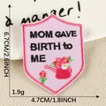 Pink shield embroidered patch featuring 'MOM GAVE BIRTH TO ME' slogan and flower design - Shield Mother's Love Style (2026.6.27) / Hot Melt Adhesive