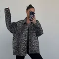 Detail view of a vintage grey leopard print denim jacket with a loose fit and lapel - S / Tops / Gray