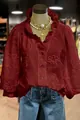 Detailed view of maroon V-neck blouse with floral embroidery and puff sleeves - S / Tops / Burgundy