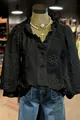 Close-up detail of a black V-neck blouse featuring floral embroidery and ruffle puff sleeves. - S / Tops / Black