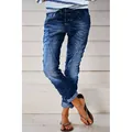 Detailed view of women's washed blue denim casual jeans featuring a stylish button fly - XS / Bottoms / Dark Blue