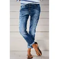 Detail view of distressed blue denim jeans for women with vintage washed finish - XS / Bottoms / Medium Blue