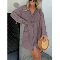 Fashionable model wearing a vintage purple acid wash V-neck denim shirt dress outdoors. - Grey Purple