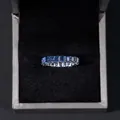 S925 silver eternity ring with emerald cut blue moissanite stones in a jewelry box - Royal Blue Moissanite Style (BR2046) / Sapphire Blue / US Size 6