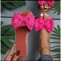 Vibrant hot pink flat slide sandals featuring a large fabric bow and rhinestone trim edge. - 36 / Rose Red