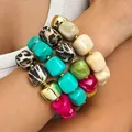 Close-up detail of vibrant handmade Bohemian beaded bracelets featuring leopard and colorful beads. - 4-Piece Bracelet Set / Mixed Colors