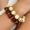 Close-up of Bohemian handmade beaded bracelets with amber and ivory beads and gold spacers - 2-Piece Bracelet Set / Mixed Colors