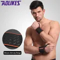 Pair of orange adjustable sports wrist wraps featuring non-slip silicone wavy grip design - 2-Piece Set / Orange